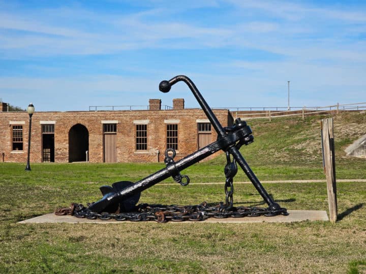 Large black anchor in the grass of Fort Gaines