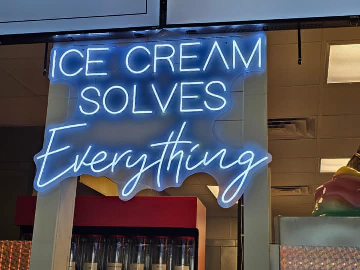 Neon sign that says Ice Cream Solves Everything. 