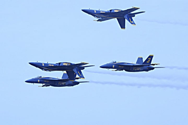 Four Blue Angels jets with two upside down next to each other