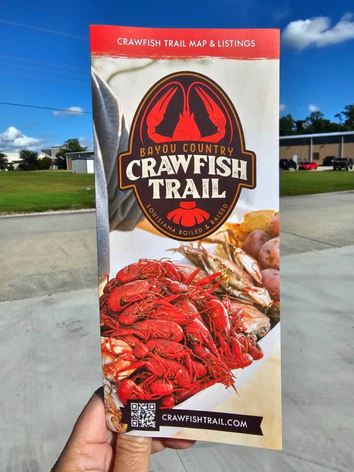 Crawfish trail brochure being held up 