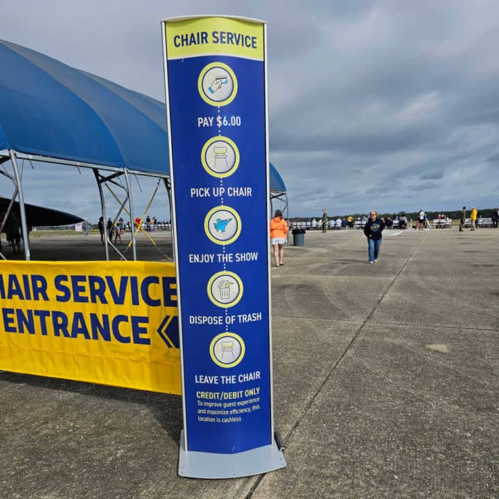 Chair rental sign with prices next to a Chair Service Entrance Sign