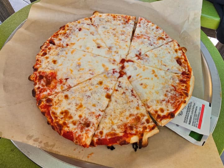 cheese pizza on a paper lined tray