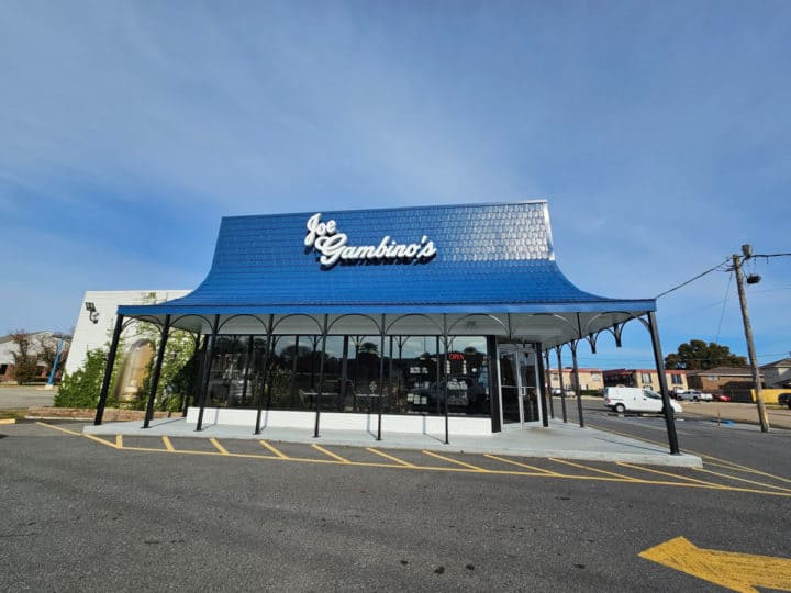 Joe Gambino's white lettering on a blue awning above a bakery with large windows