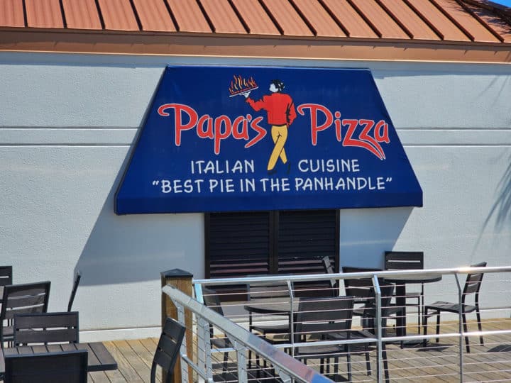 Papa's Pizza blue exterior awning sign with Italian Cuisine, Best Pie in the Panhandle printed on it. 