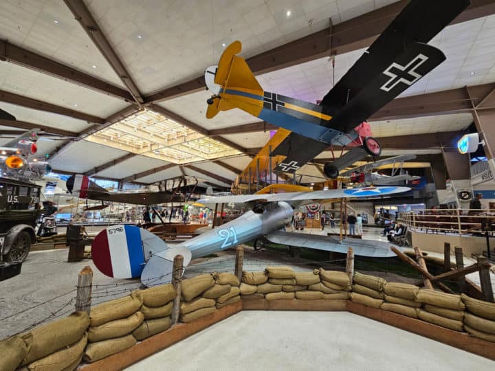 Historic planes on display in the museum with sandbag barrier