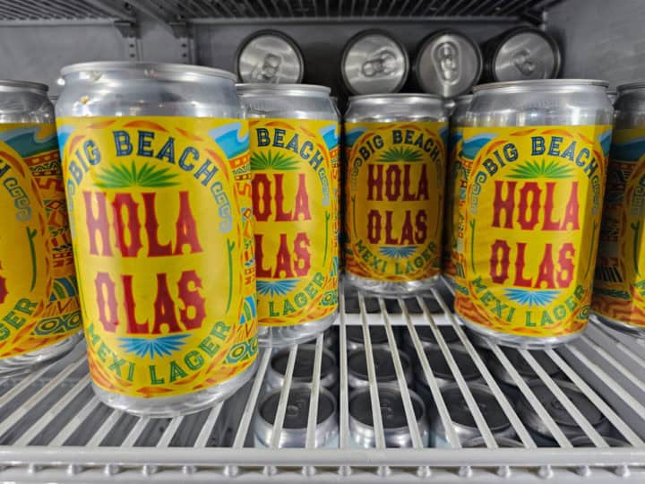 Hola Olas Mexi Lager cans in a fridge