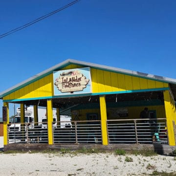 Bright yellow building with Islander Food Shack sign on it