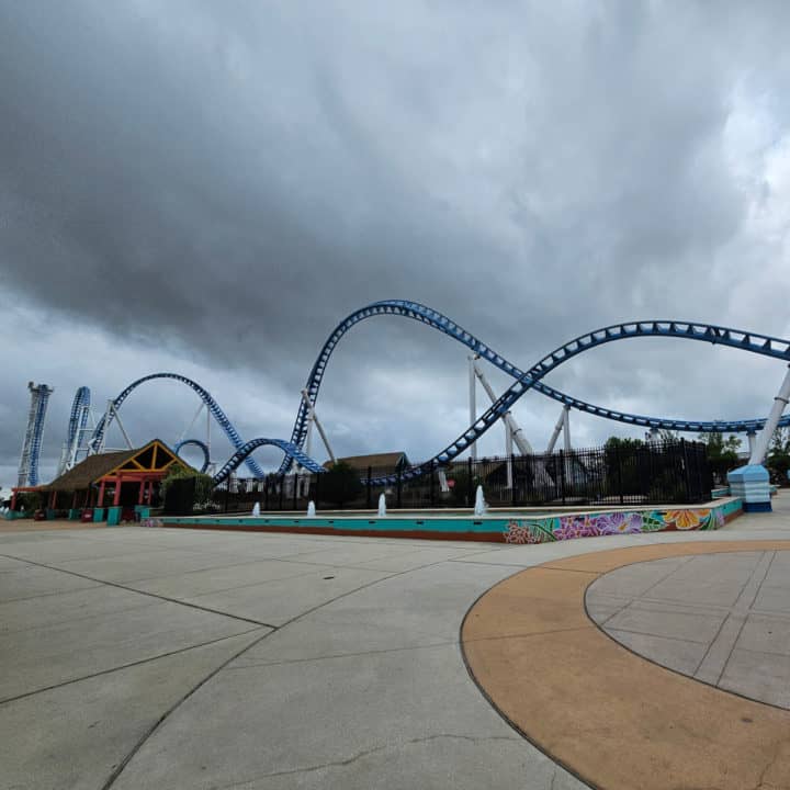 Large blue roller coaster on a cloudy day