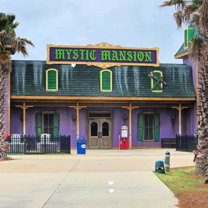 Mystic Mansion sign above a two story haunted house building