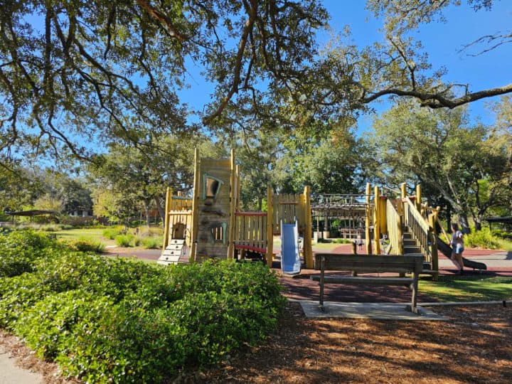 Play structure under trees in the shade. 