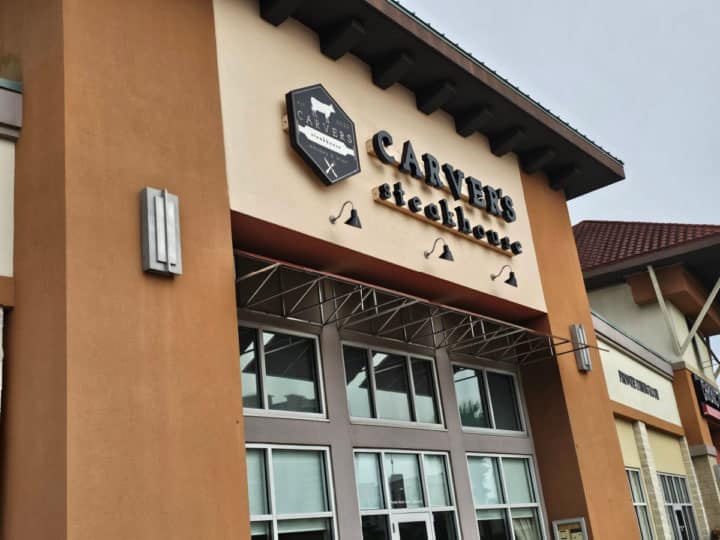 Carver's Steakhouse logo and sign on the front of the building with glass windows and entrance door
