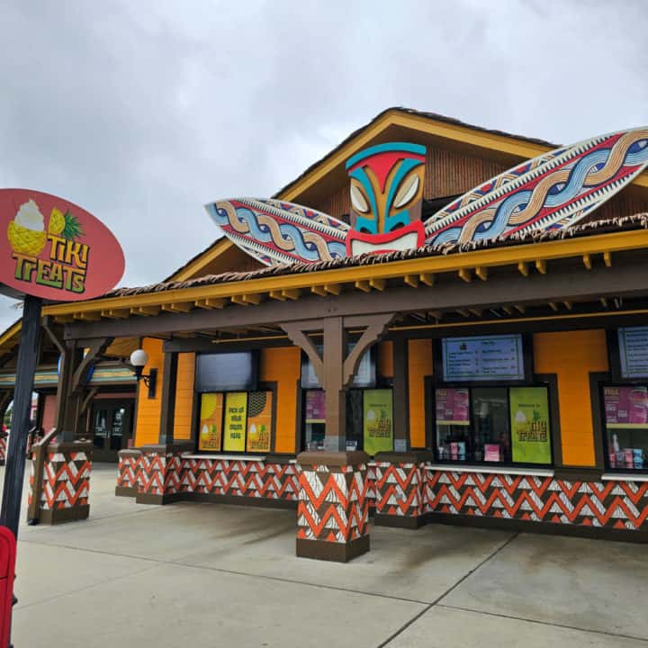 Tiki Treats sign next to a multi color food stand