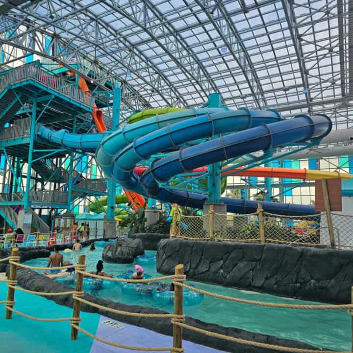 Three blue waterslides forming a large 360 over the lazy river