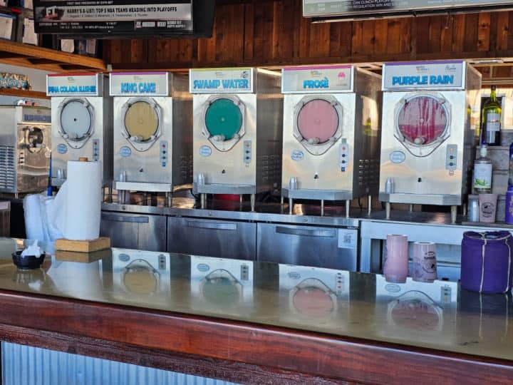 Frozen drink dispensers in a line behind the bar
