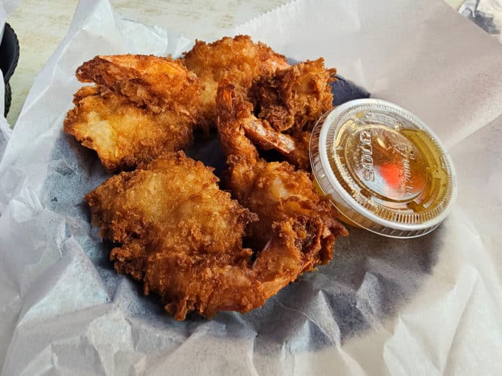 Coconut shrimp with sauce in a paper lined basket