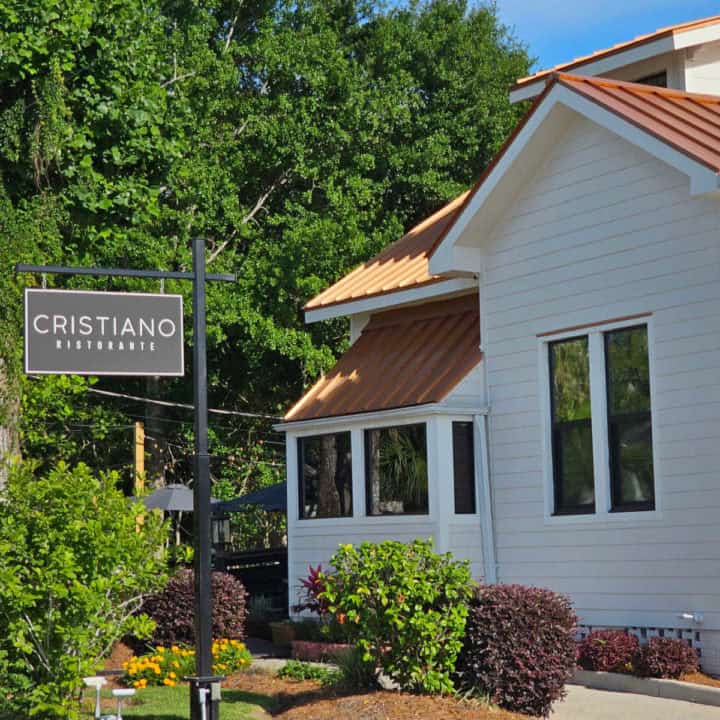 White building with a Cristiano Ristorante sign next to it