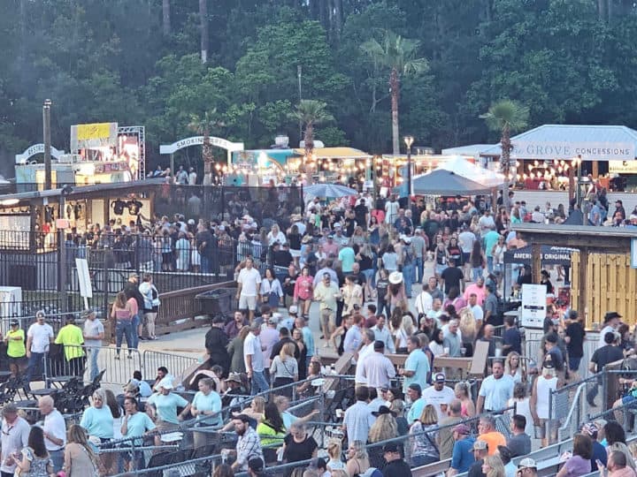 crowds of people near concession stands in the Wharf Ampitheater