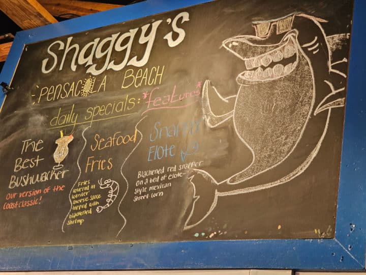 Shaggy's daily specials menu on a chalkboard with a shark drawing