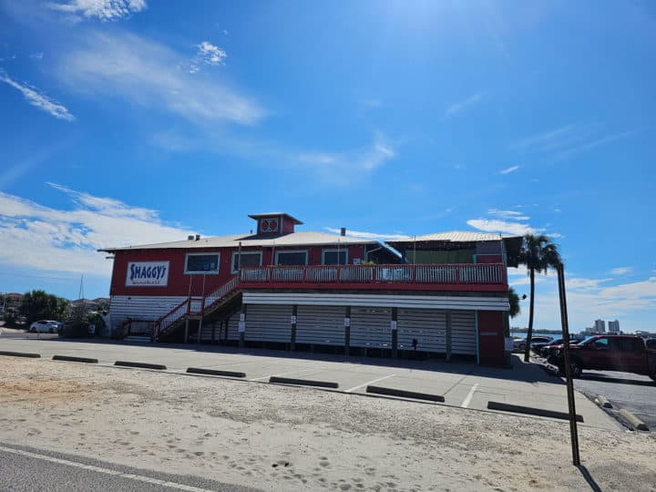 red and white two story building with a large sign for Shaggy's on the side of the building