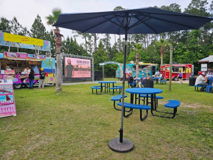 grassy area with food trucks and seating