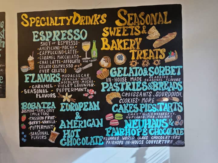 Specialty drinks and seasonal sweets menu on chalkboard 