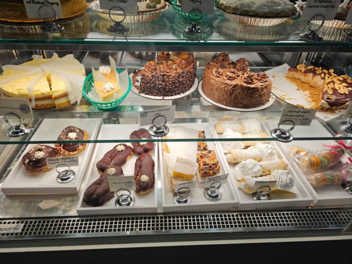cakes and eclairs in a pastry case