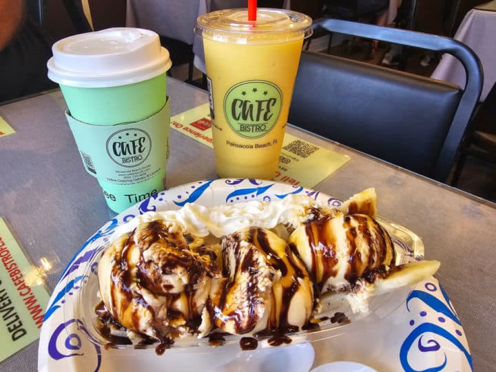 banana split next to two cups with Cafe Bistro logo on them. 