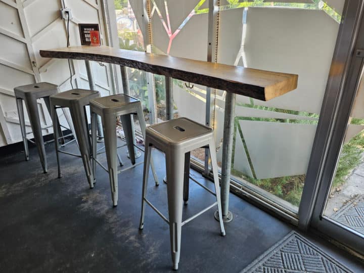 tall stools near a counter next to a window