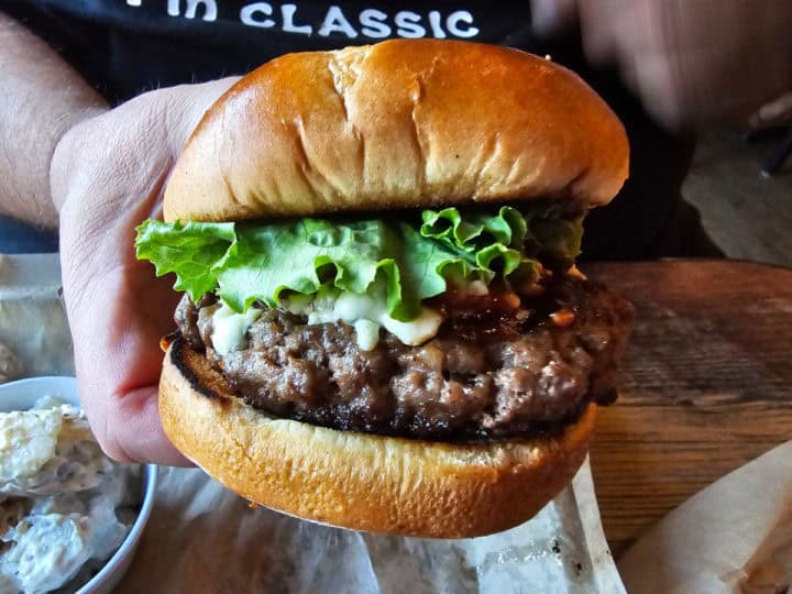 Bison burger with blue cheese and lettuce on a brioche bun