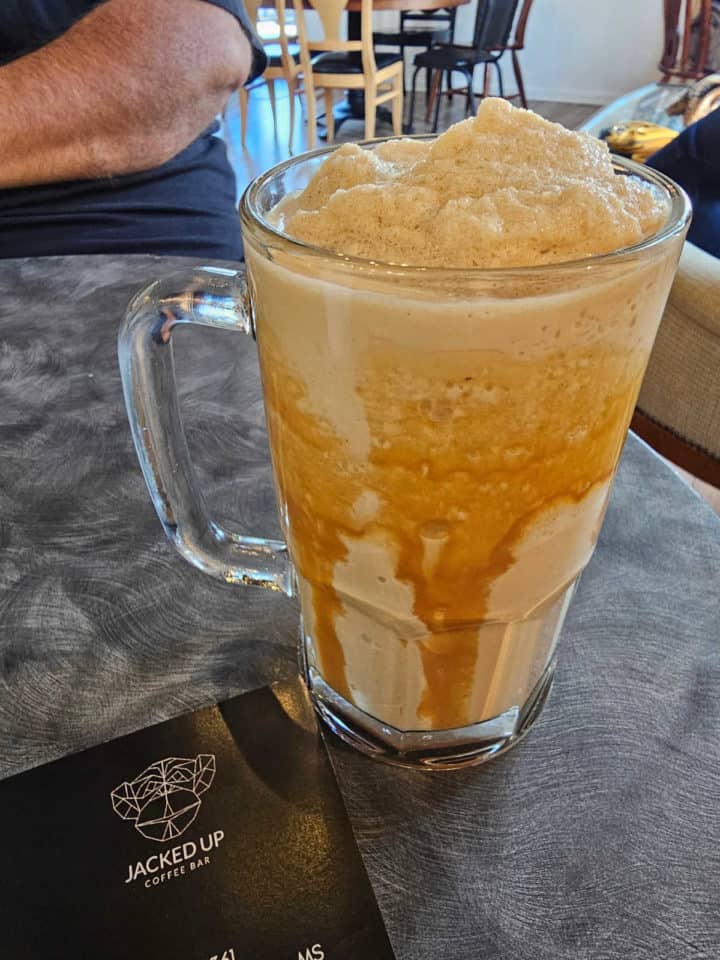 tall mug with an iced blended caramel coffee drink