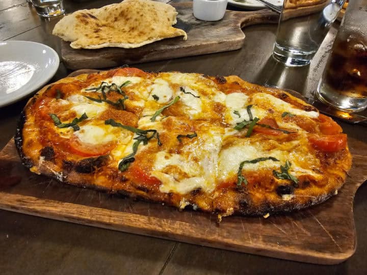 Cheese pizza on a cutting board