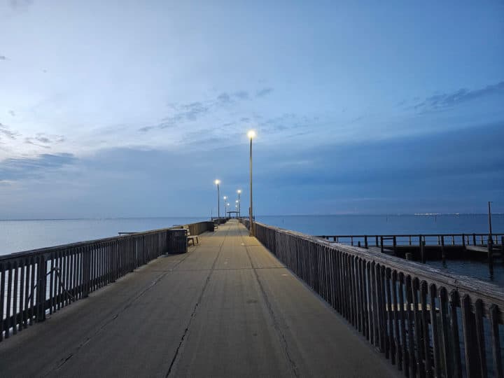 evening on the fairhope pier with lights and darkening sky