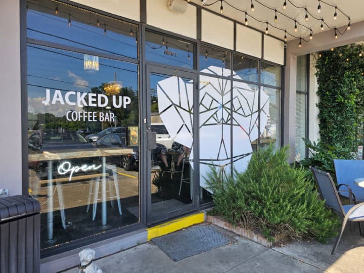 Jacked Up Coffee Bar text next to a monkey on a window 