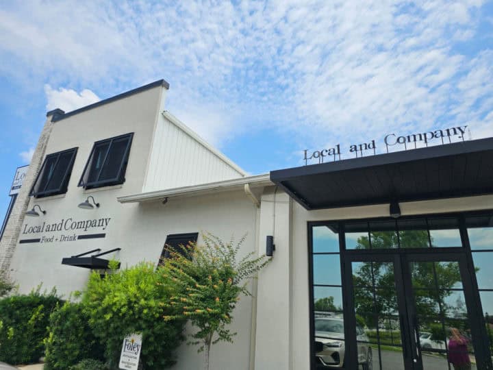 Local and Company white building exterior with black sign with restaurant name