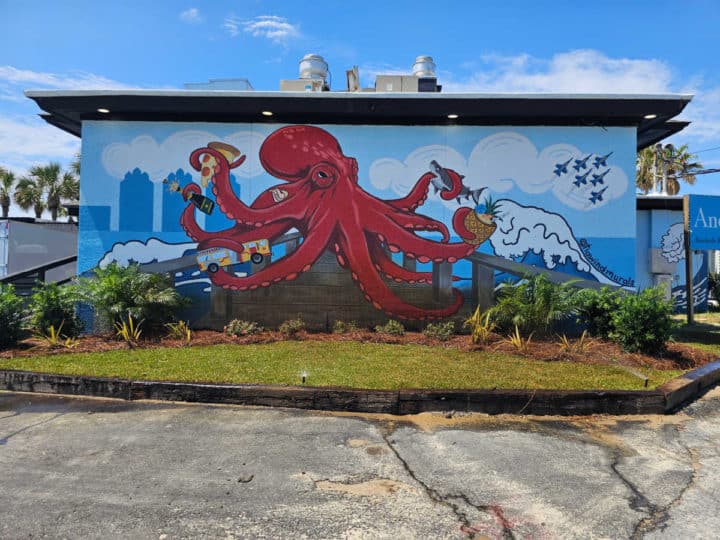 Octopus mural holding a shark and the Blue Angels flying in the corner