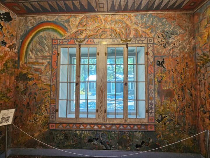 rainbow and nature mural on the little wall room