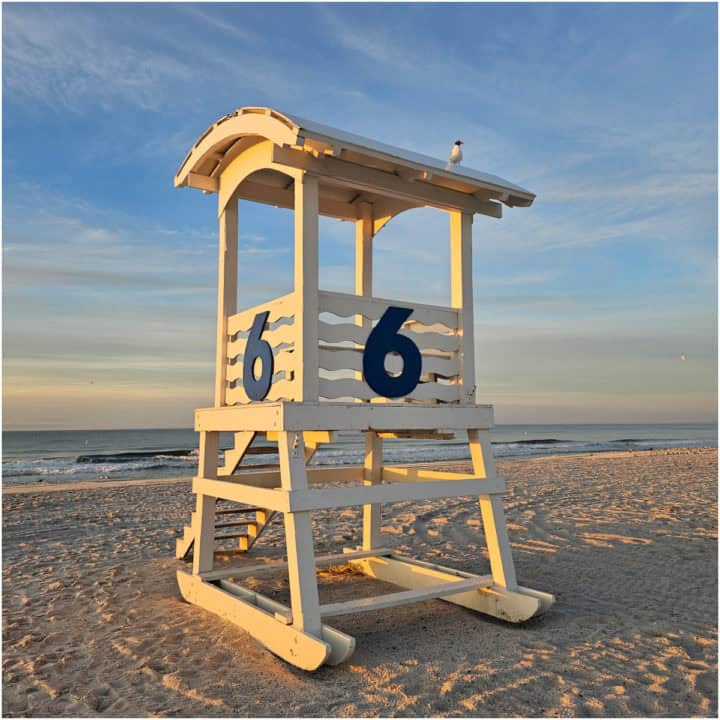 White lifeguard stand with a large number 6 on it. 