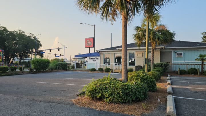 Parking lot and exterior with Nonna's Pizzeria Sign in the background