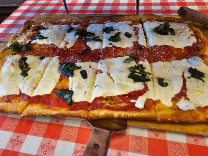 Square Margherita Pizza on a red and white checkered tablecloth