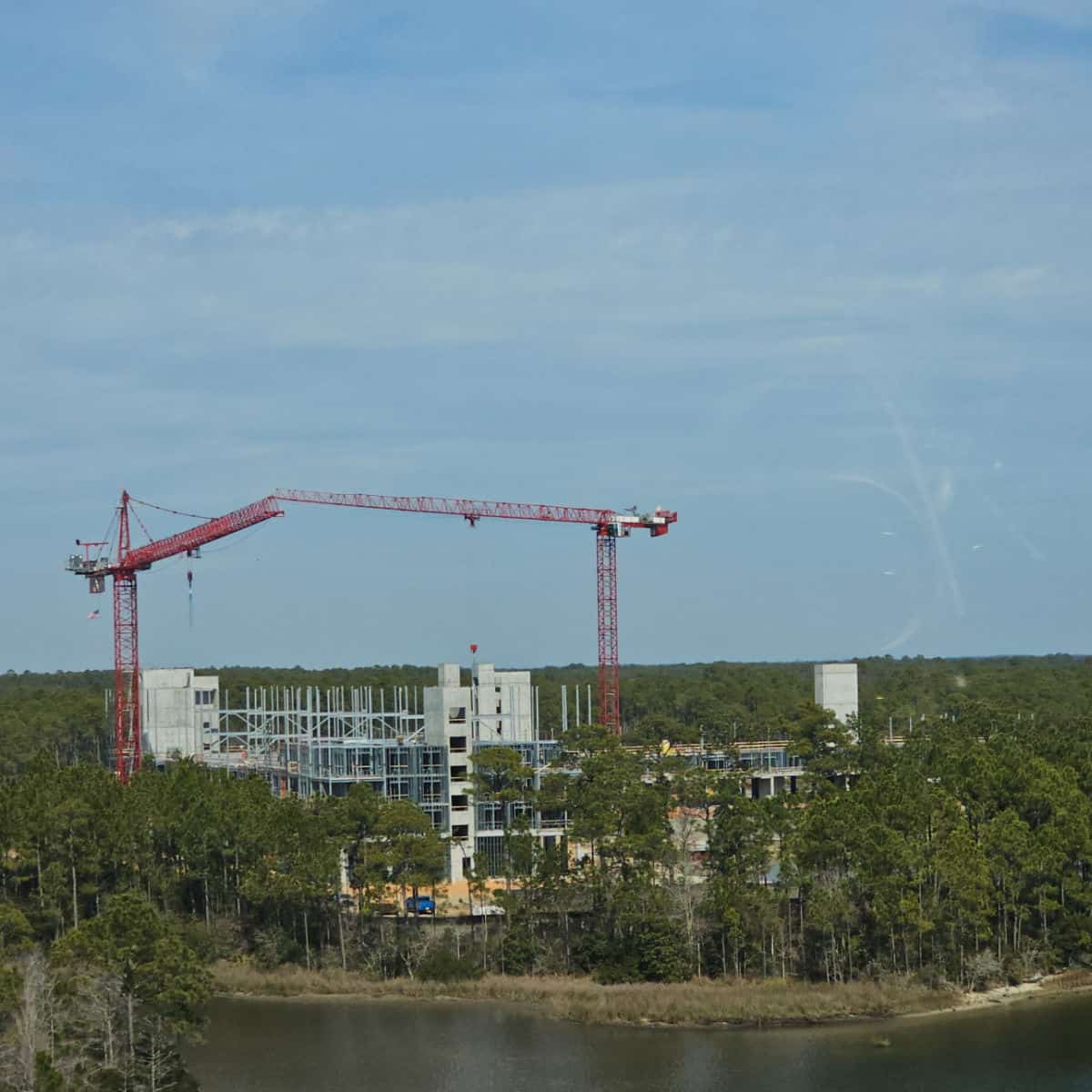 Two construction cranes and concrete work are building the new Margaritaville Resort Orange Beach