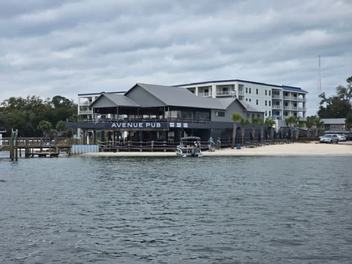 Avenue Pub from the water with sandy beach next to it