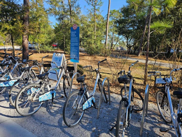 bikes lined up next to a bicycle share station sign