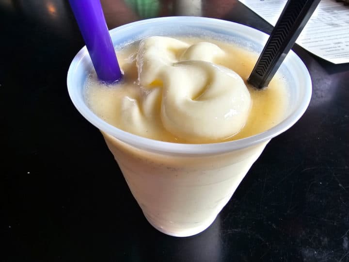 Blonde bushwacker in a plastic cup with two straws