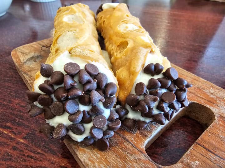 Chocolate Chip cannoli on a wooden board