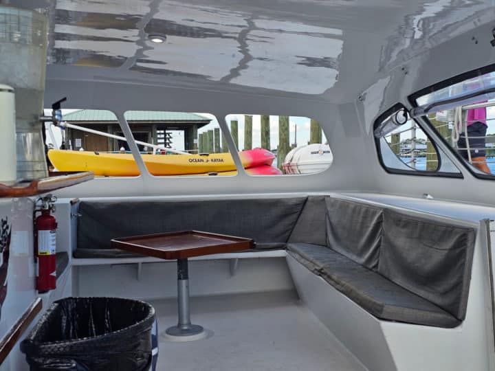 Covered seating with a small table looking out over the sailboat