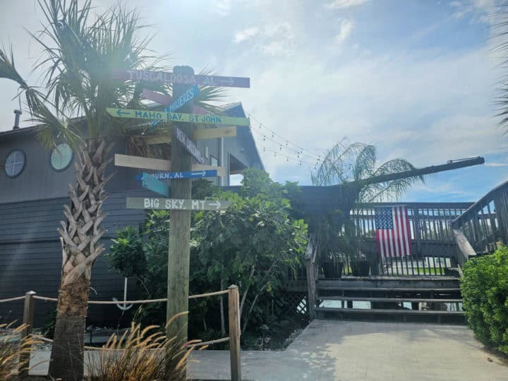 Pirate ship shaped restaurant with directional signage in front of it. 