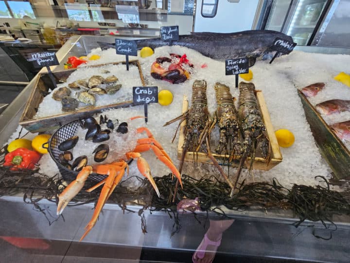 crab legs, lobster, and fresh seafood displayed on ice