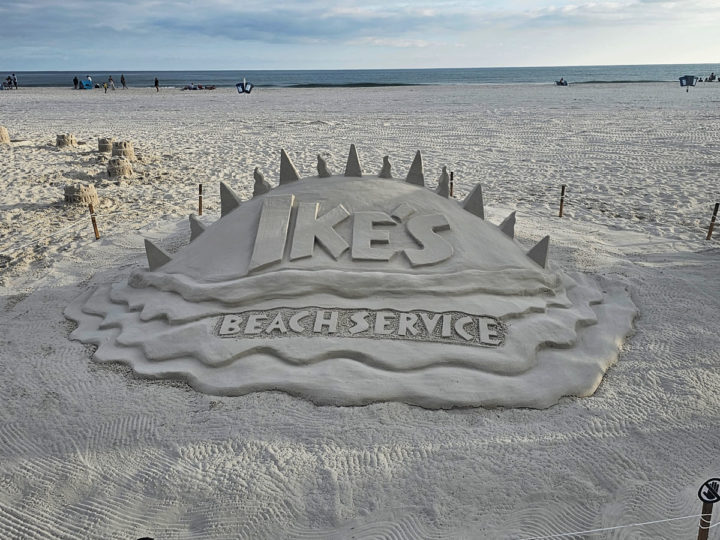 Ike's Beach Services sand sculpture with the Gulf in the background