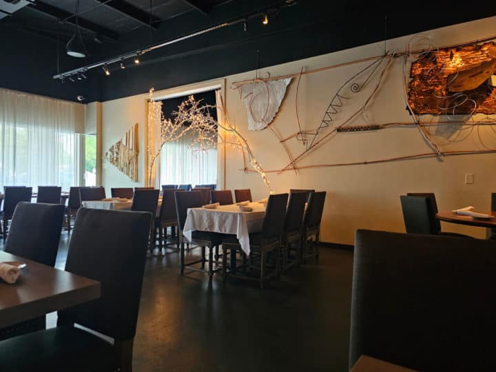 indoor eating with tables and chairs, artwork on the walls in Big Fish