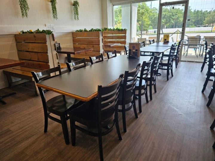 Indoor tables and chairs next to wooden booths